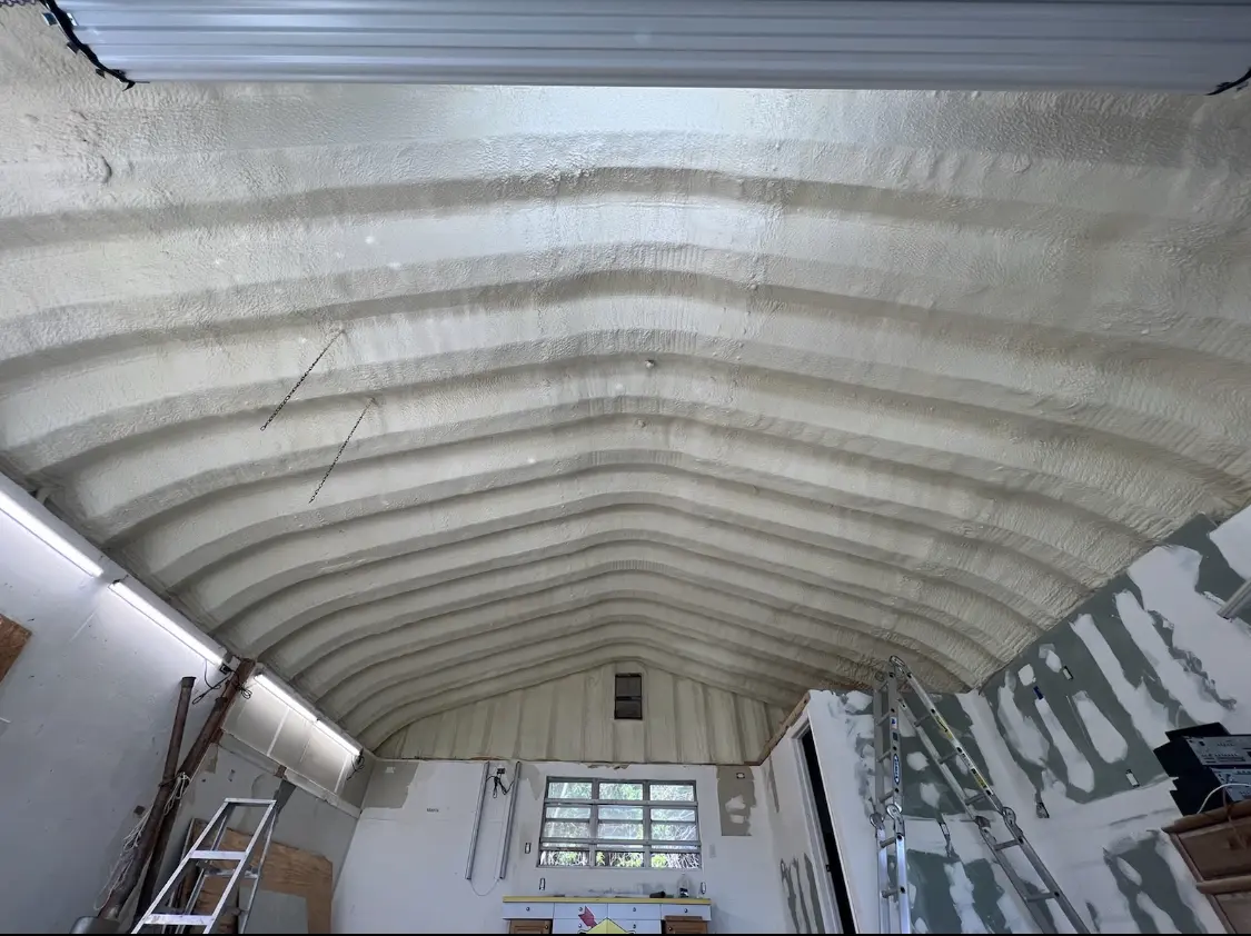Spray polyurethane foam applied to the underside of a metal roof deck in Des Moines